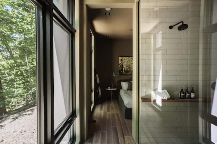 Master bed and bath with floor to ceiling glass and windows