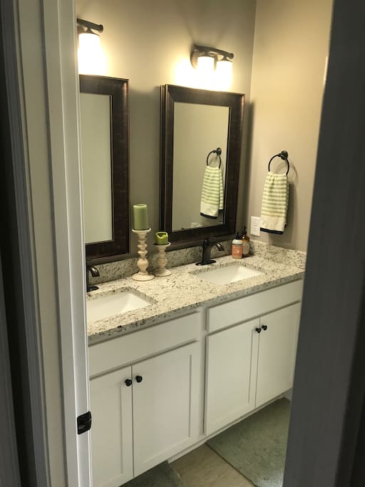 Bathroom with dual vanity. Attached is a separate room with shower and toilet