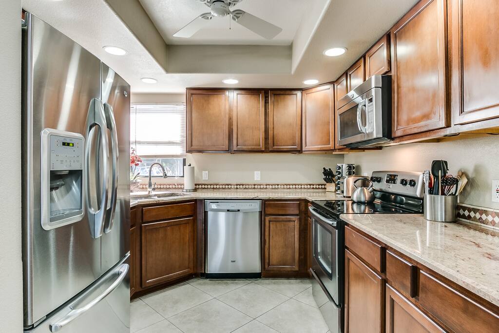 The refrigerator is a full size Maytag with french doors, ice & water dispensers and bottom freezer.