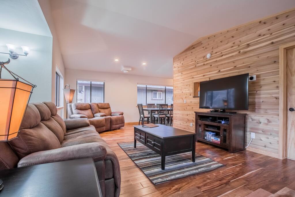The upstairs includes a half bath, newly furnished living area, dining table, and kitchen