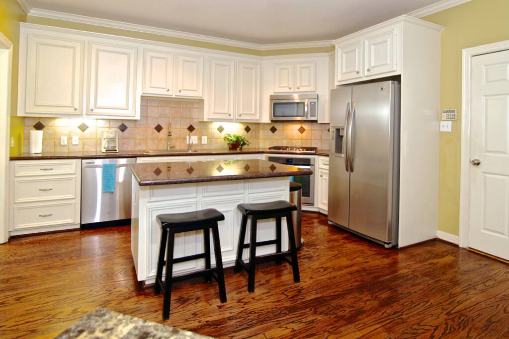 fully equipped kitchen with modern appliances, cookware, flatware etc