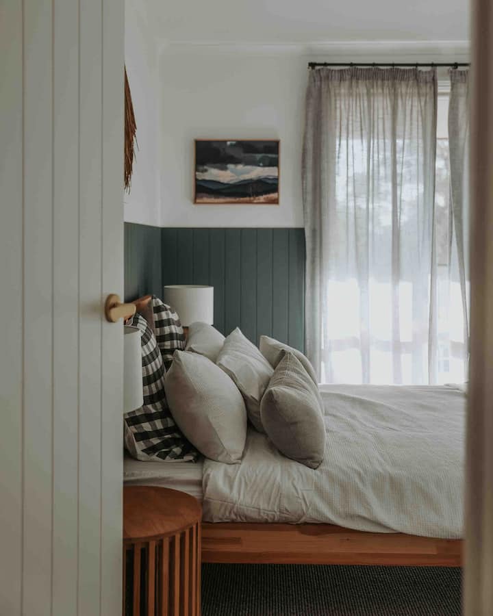 Large bedroom 2 in The Chalet on main level. Queen bedroom with views of the upper terrace and tennis court.