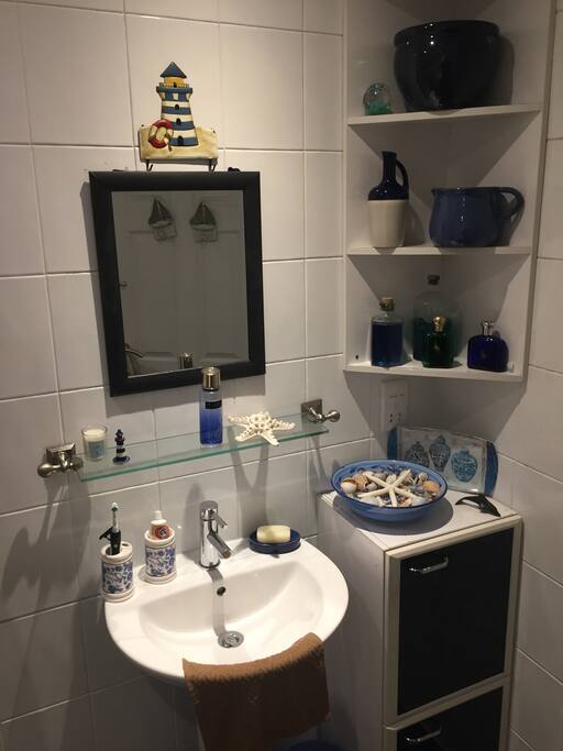 Shared Bathroom between two bedrooms Overhead shower and bath toilet with wash hand basin