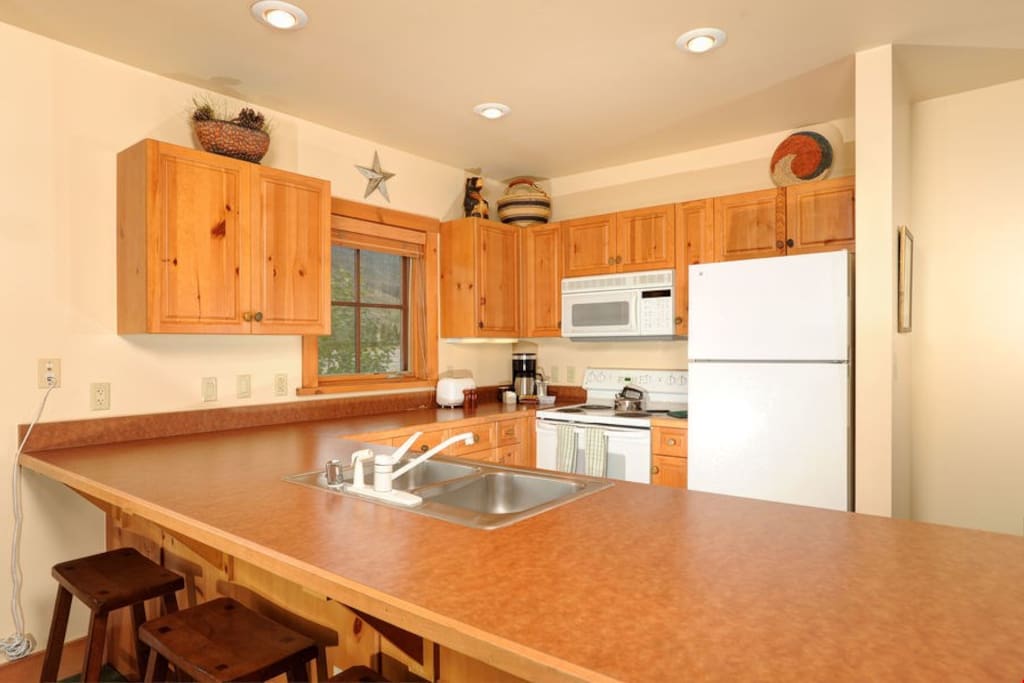 The fully-equipped kitchen features lots of counter space and a breakfast bar