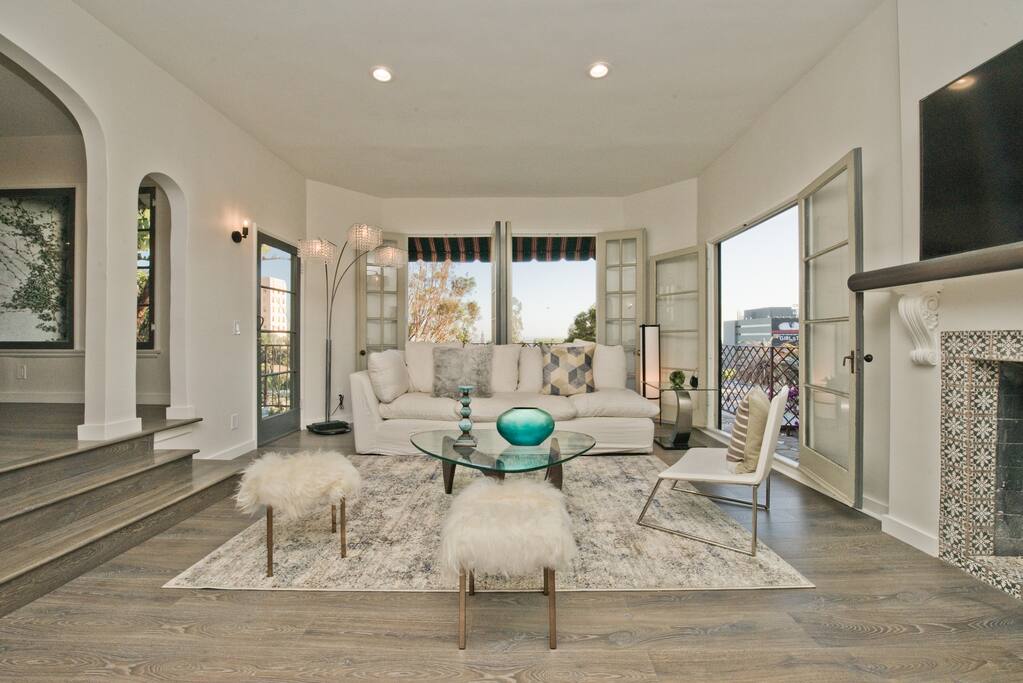 View of Villa living room with all the doors opened, there are 3 decks on the villa floor one to left with balcony, one straight and one to the right