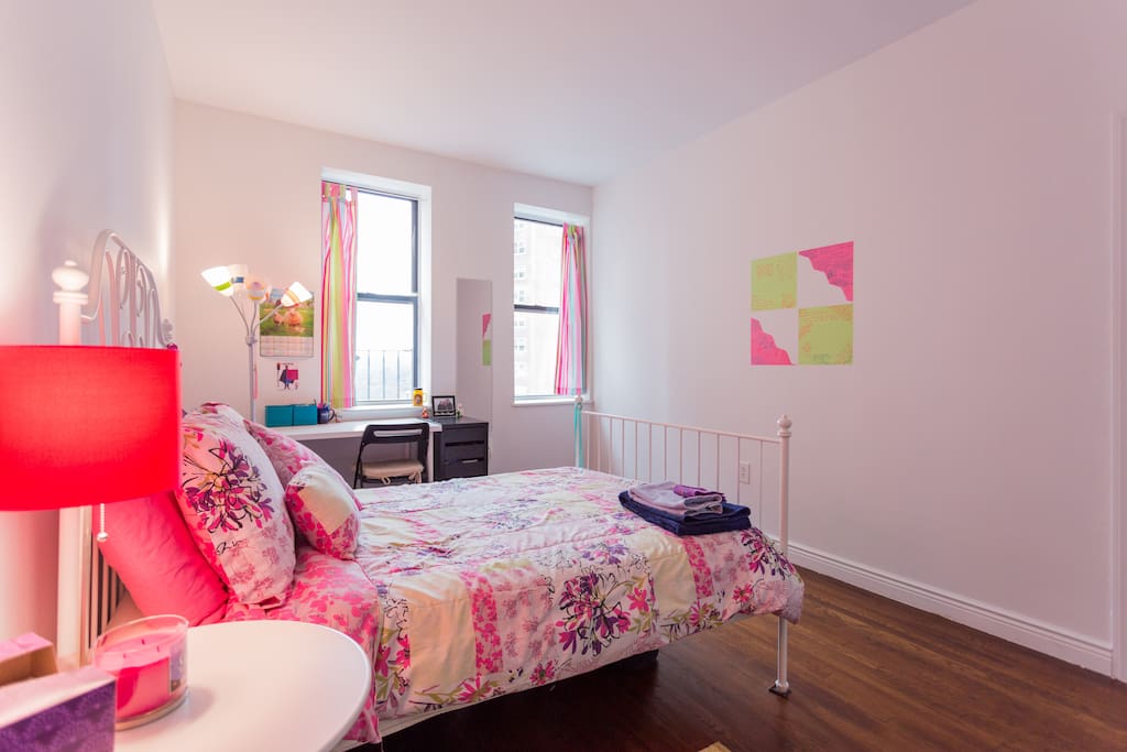 Bright bedroom with plenty of space and sunny views of Fort Tryon Park