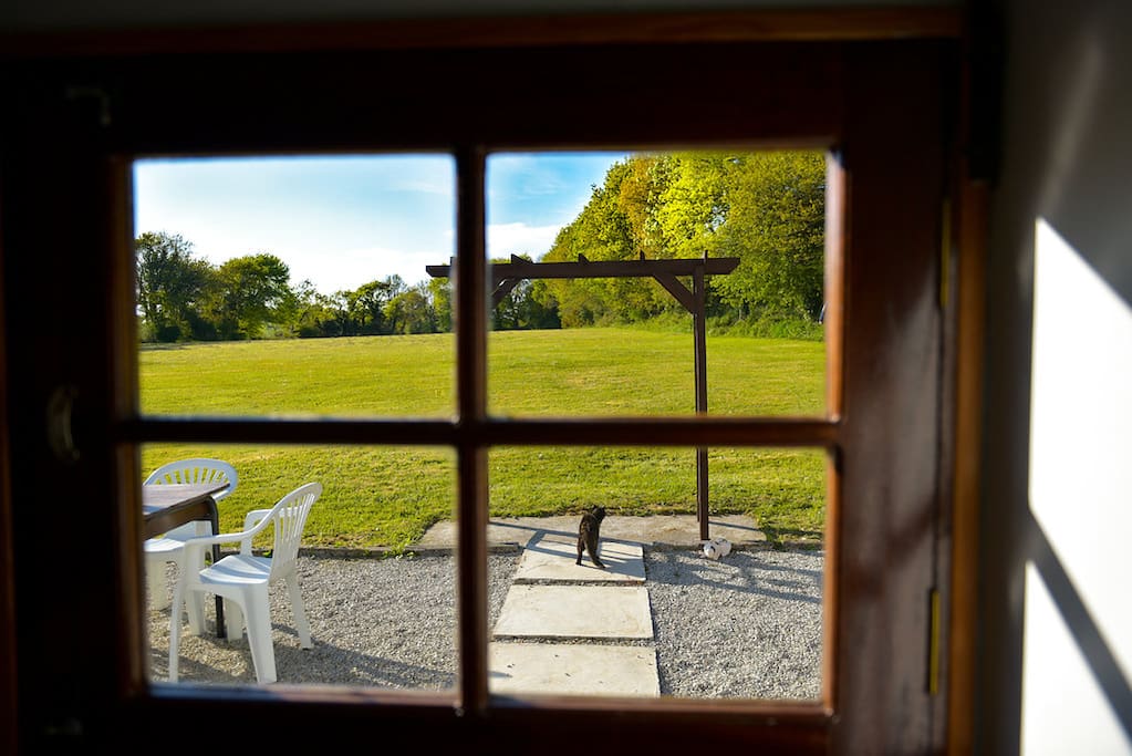 view from the kitchen stable door over the field and outdoor dining area