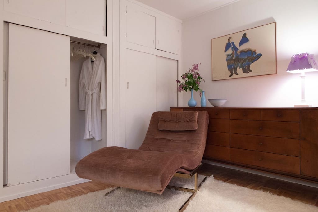 Bedroom w/ 4 closets, lounge chair, and dresser