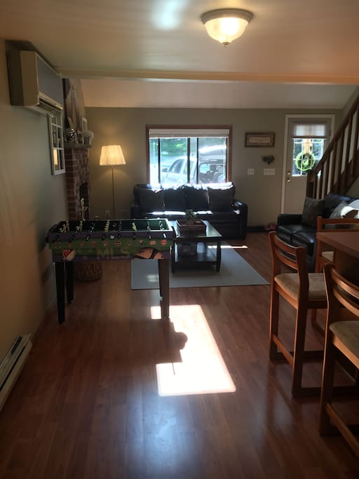 Living room with new leather couches and game table.