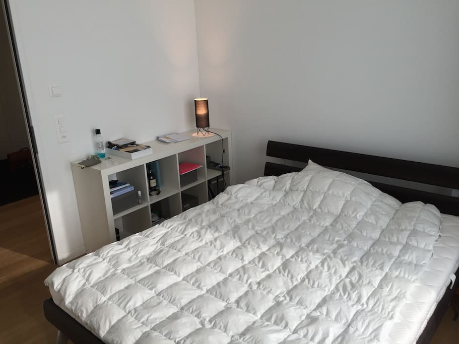 12qm bedroom with a large bed and a big window