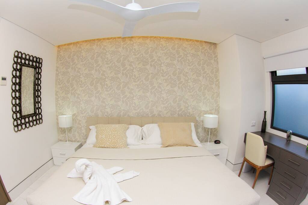 Hermosa cama King size con aire condicionado y un pequeño escritorio