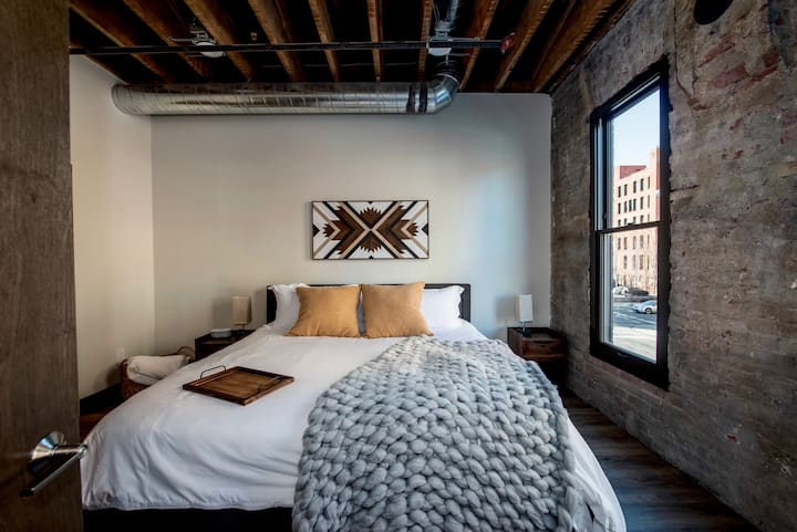 Master bedroom with King bed. Art featured by local artist CJ Morrison @roamingrootswoodworks