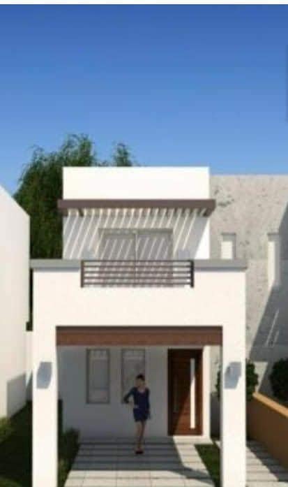 The modern two-story house features a clean white facade with horizontal wooden accents. A covered porch is framed by symmetrical columns, and a pathway lined with pavers leads to the front door. Lush greenery is present to the side of the property.