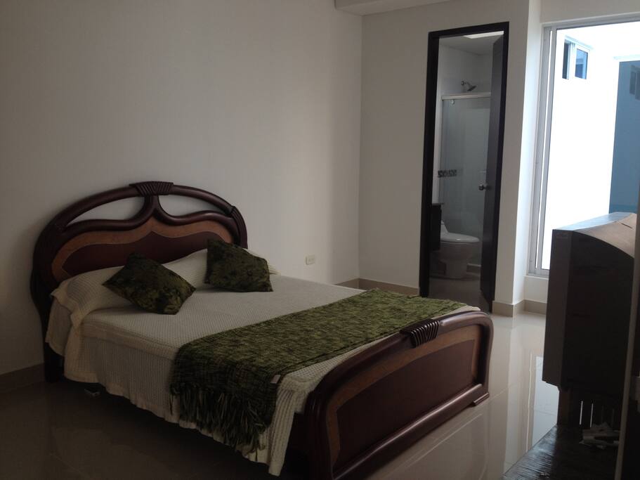 Cuarto principal con baño privado y aire acondicionado.