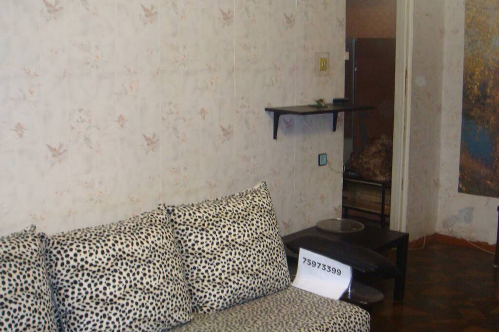 Large room with sofa and air conditioning.