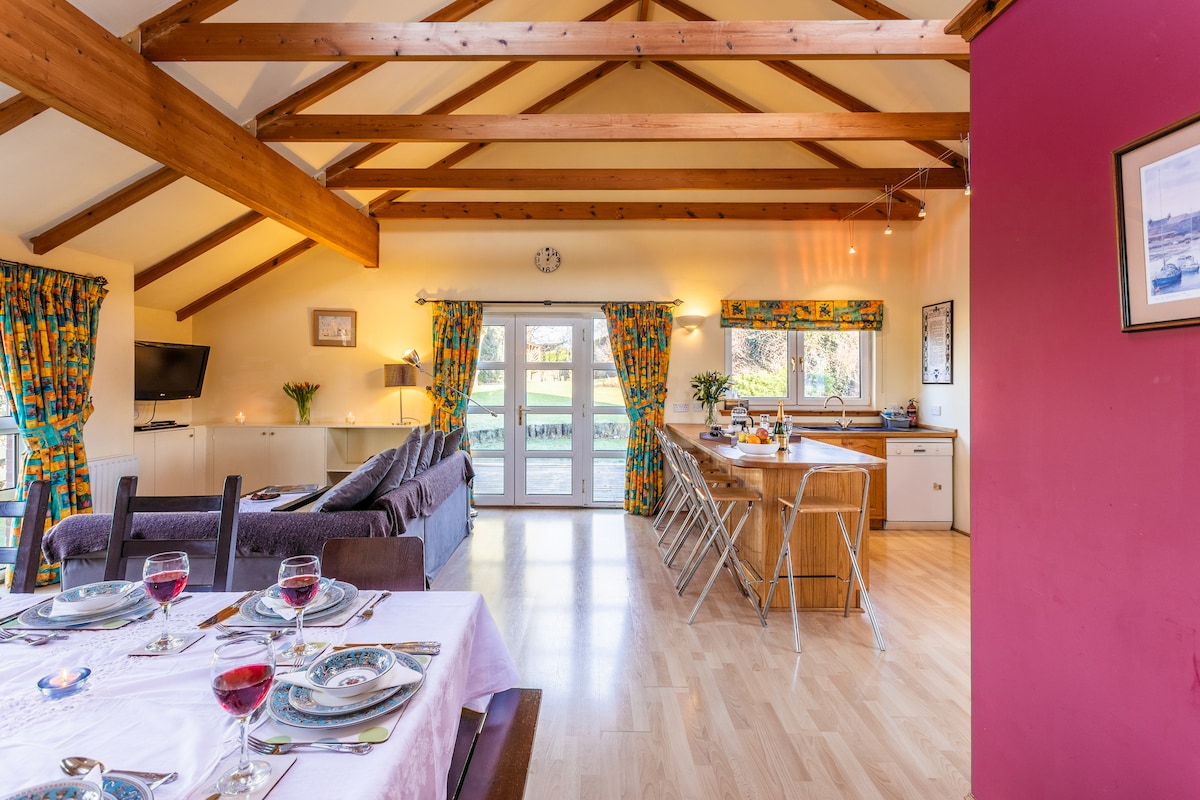 A capacious kitchen-living area with comfy seating for all - ideal for entertaining large groups of friends and family.