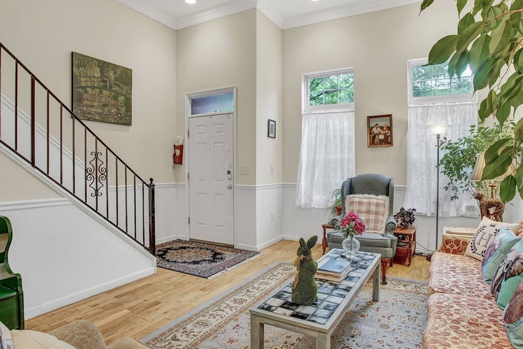 You'll enter the house from the street into the living room, and your bedroom is just up the stairs.