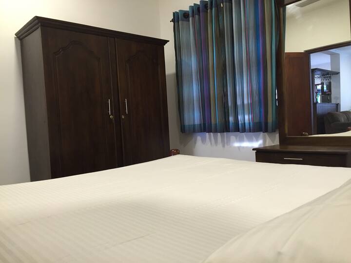 Comfortable bedroom with storage and dressing space.