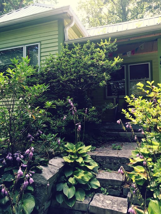 front porch tucked in the garden greens