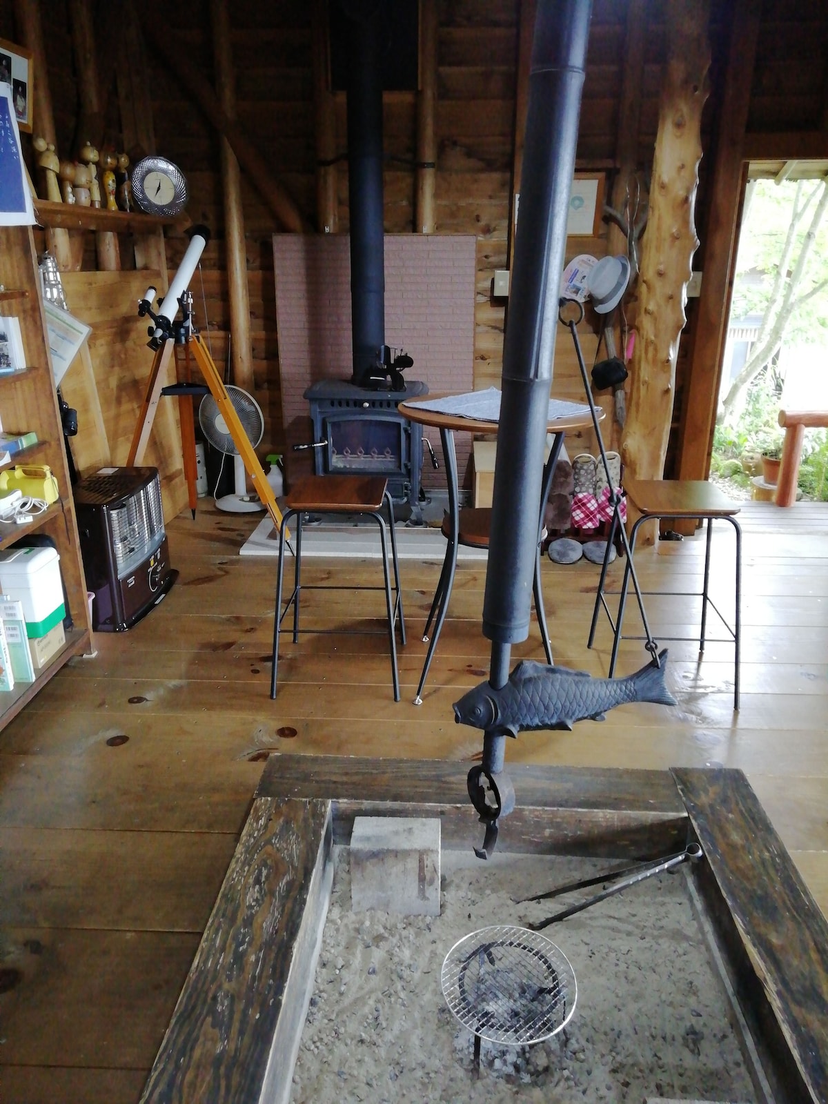 Living room with fire pit and wood stove