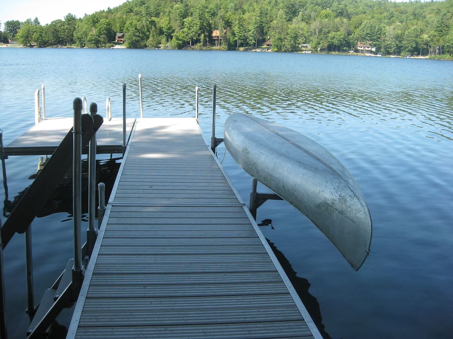 Aluminum dock with canoe. Deep water at the end. Shallow for wading nearer shore