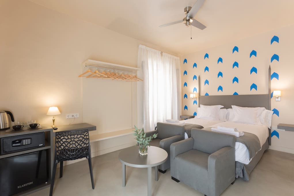 Bedroom with twin beds and complimentary basics such as coffee, tea and water.