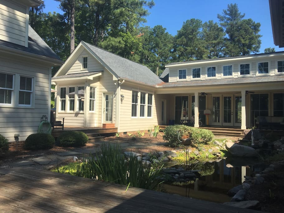Awesome back yard with covered porch and pond
