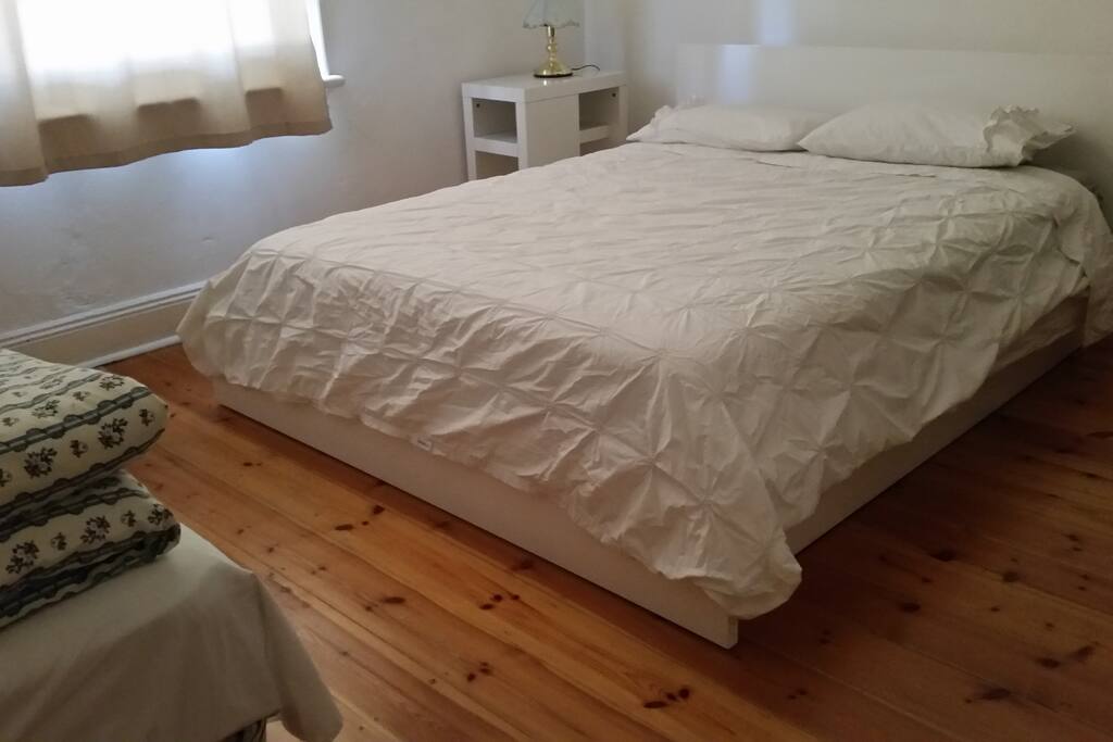 Room 1. A queen bed with a king single bed