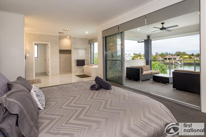 Main bedroom with ensuite, walk in wardrobe, foxtel and view of water