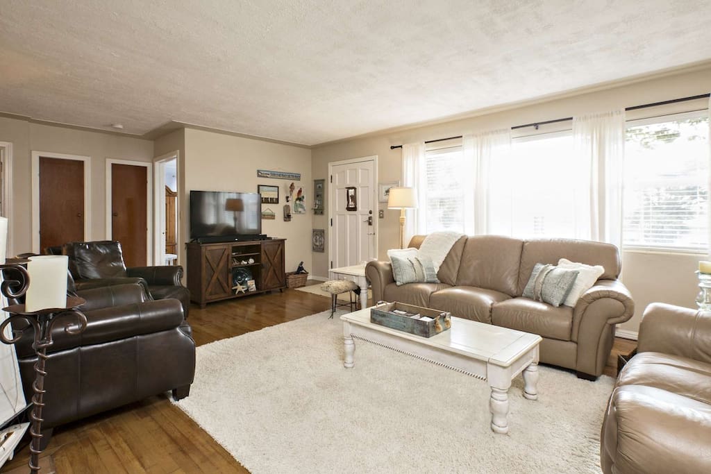 Living room features a large flat screen television, sound bar, Apple TV Box and WiFi.