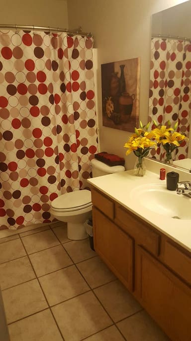 This bathroom has a tub and extra large vanity. Shampoo, soap and towels are included.