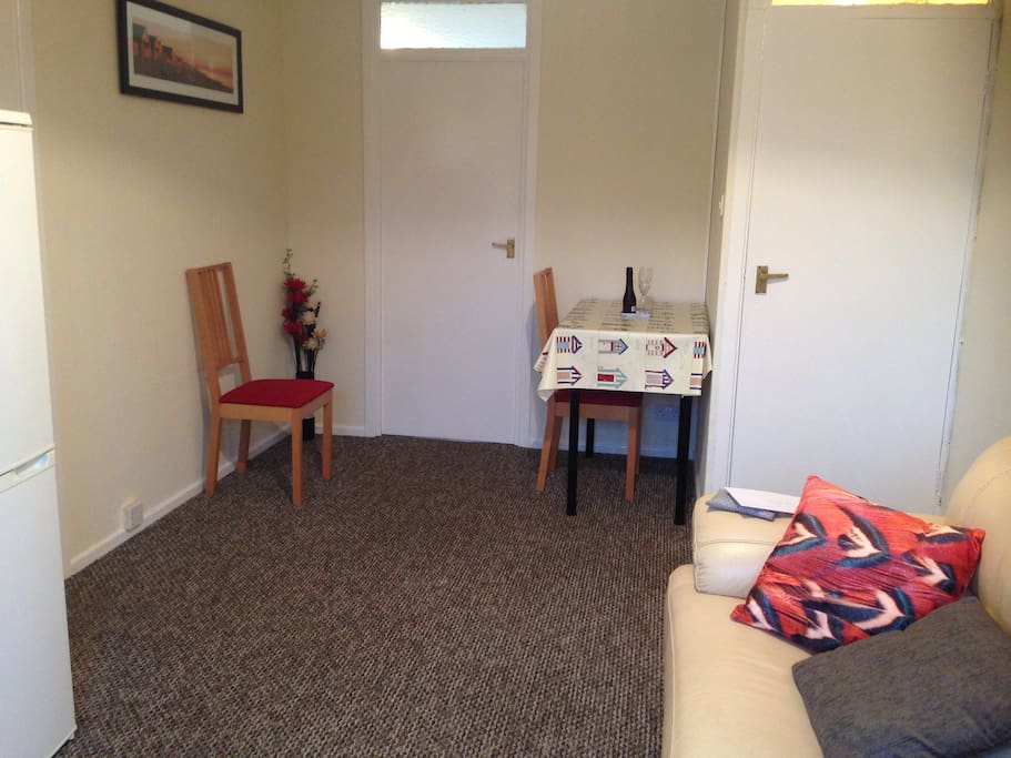 Dining area that doubles as an office when table cloth is removed and tabletop is raised-(clever!)