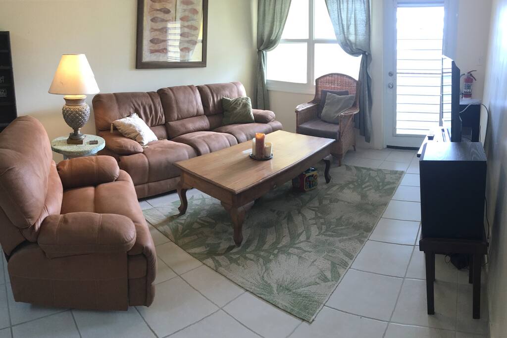 Living Room with tv, ocean view, exit to private balcony.