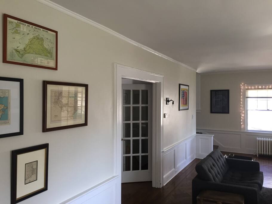 Living room leads to hallway and side entrance.