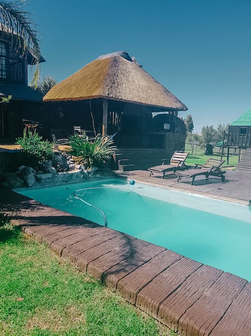 Sparkling pool with sun loungers and reading area
