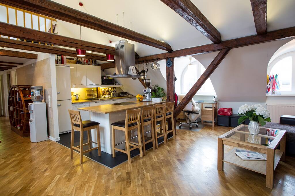 Miele kitchen, cooking island, bar for four, oak work desk and Vitra chair, sofa area and couch table.