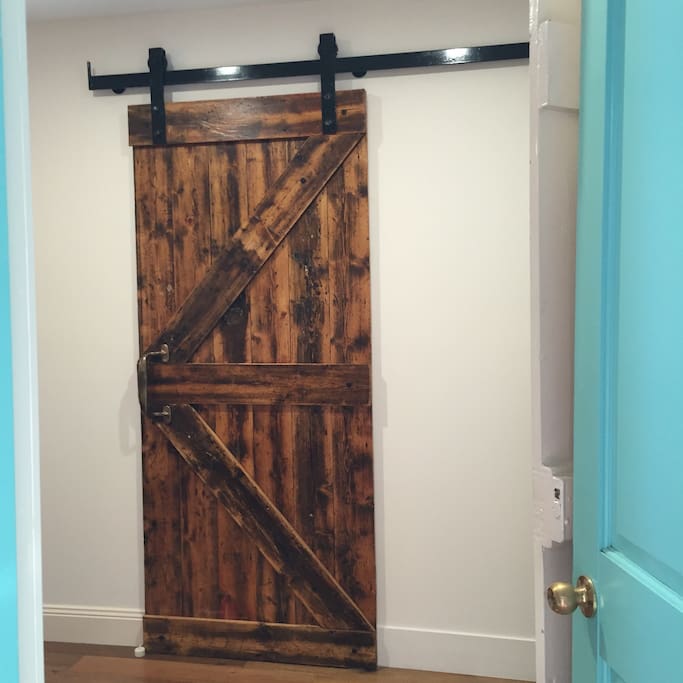 The bathroom 'barn door 'was made out of the floor boards of the original building.