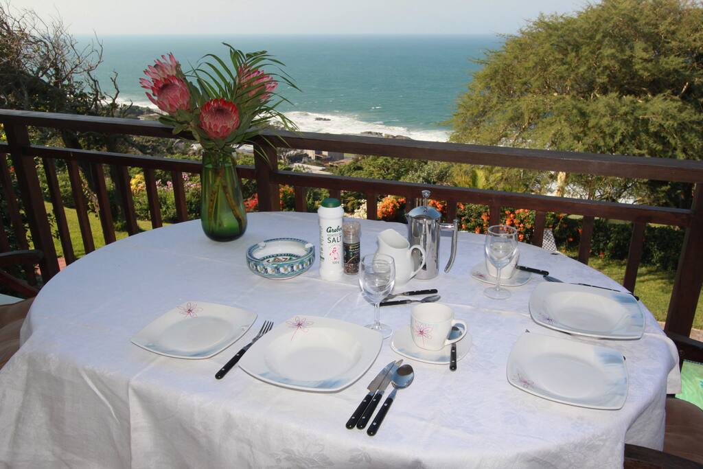 View of beach from deck with table, chairs and BBQ for your use