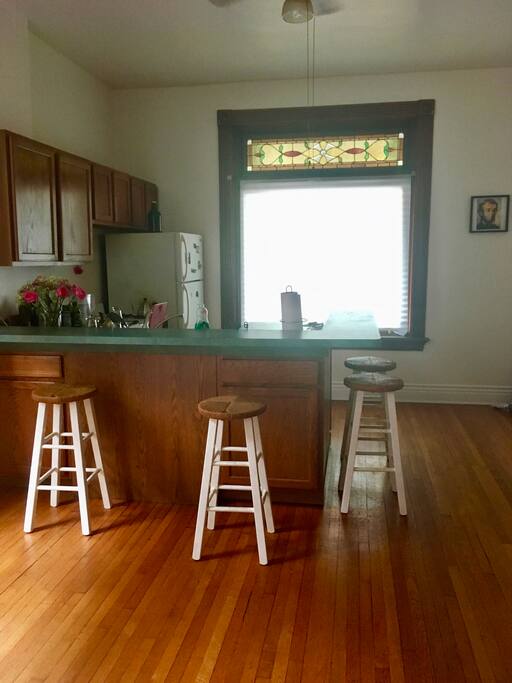 Kitchen and bar with stools that can fit 4 or more people.
