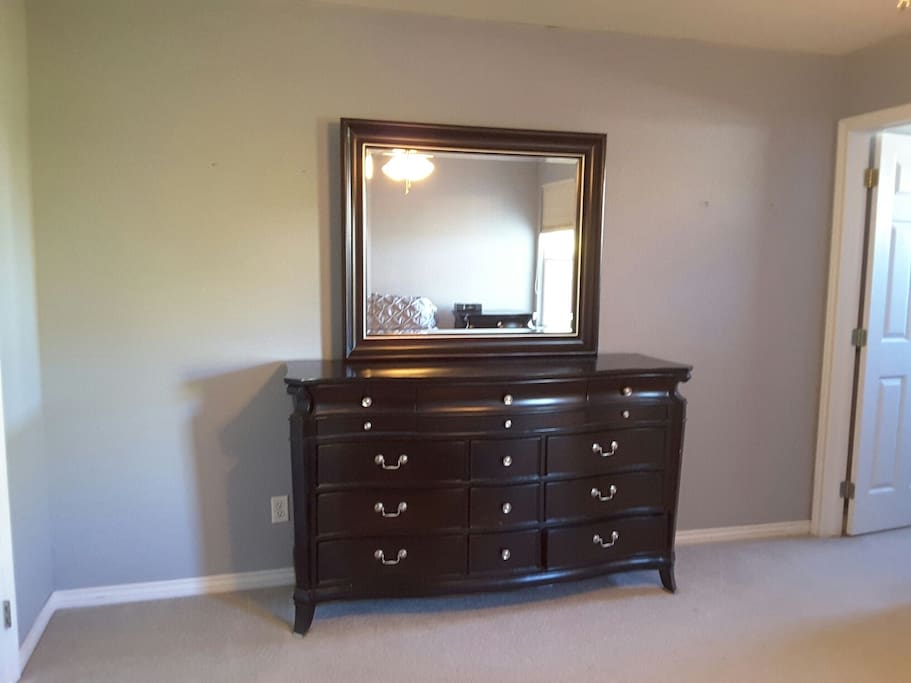 Large dresser with mirror. Includes a special drawer to store personal items such as watches and jewelry.