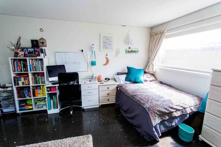 Spacious Downstairs bedroom with double bed, with digital piano and direct access to lower deck, patio and hammock.