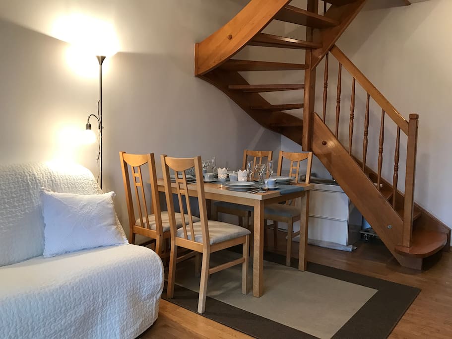 Living room with dinning table to the second floor