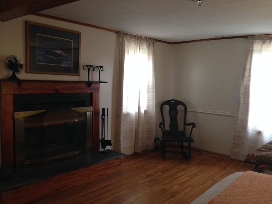 Fireplace, desk, chair, and two single (twin) beds.