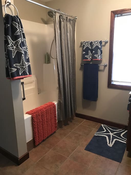 Soak in the tub or shower in this spacious bathroom space. Private toilet down the hallway.