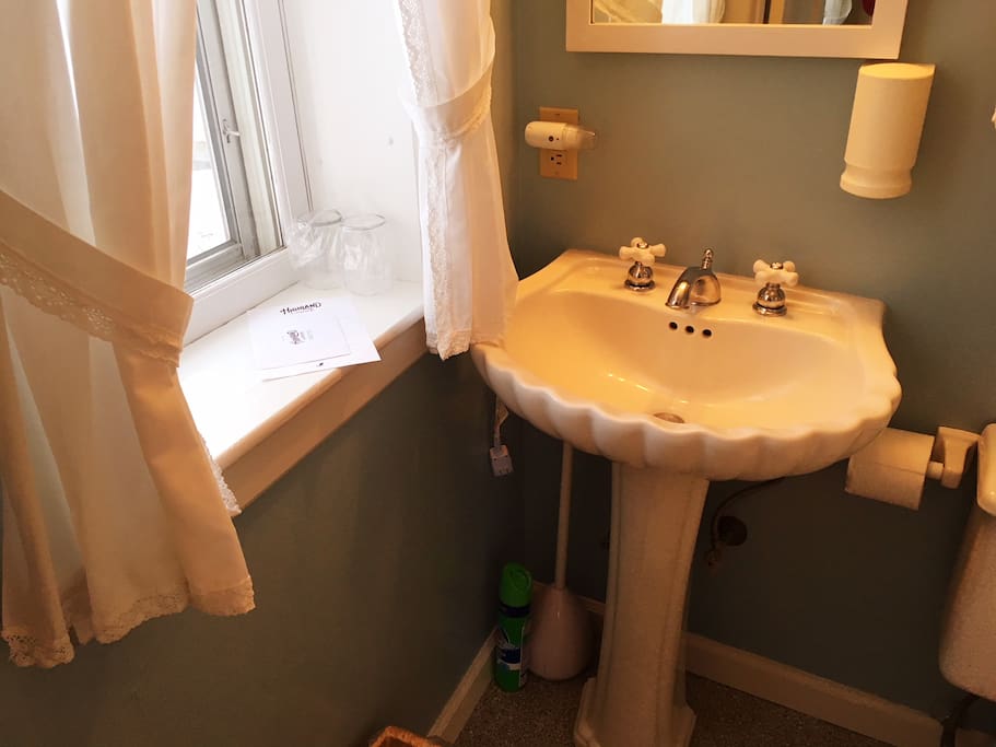 Private bathroom has natural light, tub and shower.