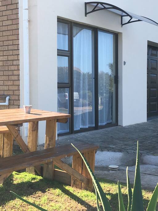 Entrance, braai area and wooden bench for outside enjoyment.
