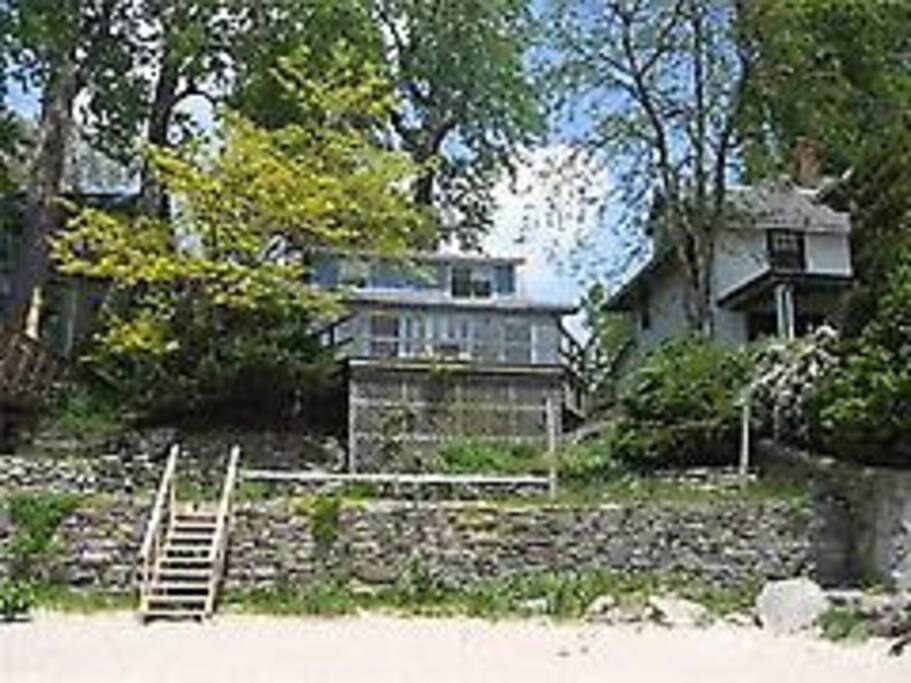 Cottage on the beach with a deck and flagstone terrace