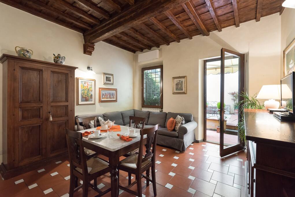 Bright living room has a window facing the patio/terrace and a glass door for easy terrace access.