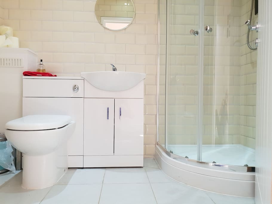 Modern, clean, stylish bathroom with effective shower, soaps and gels.