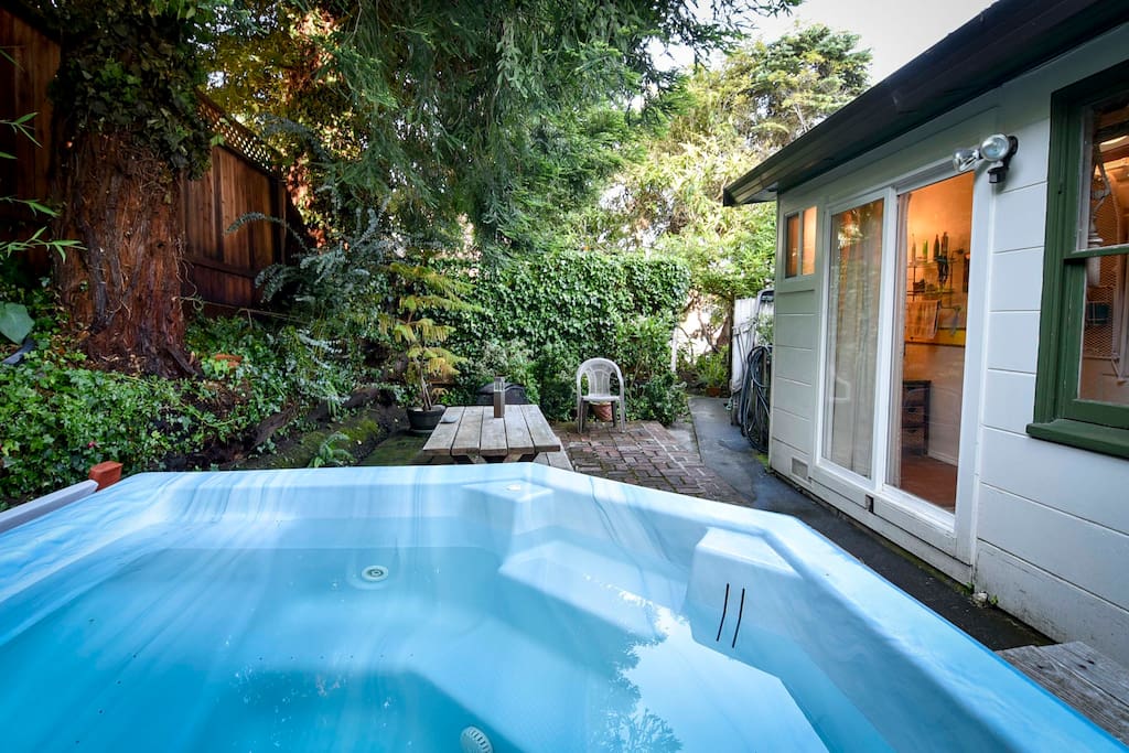 Private brick patio with a hot tub for rest and relaxation.